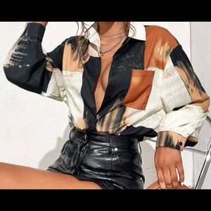 White, brown, and black brush print blouse.